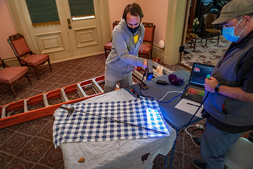 Connor Zelinsky and Frank Pereira using white light to scan John Bidwell's sword