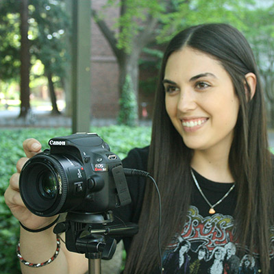 Nicole Camarda holds a camera. 