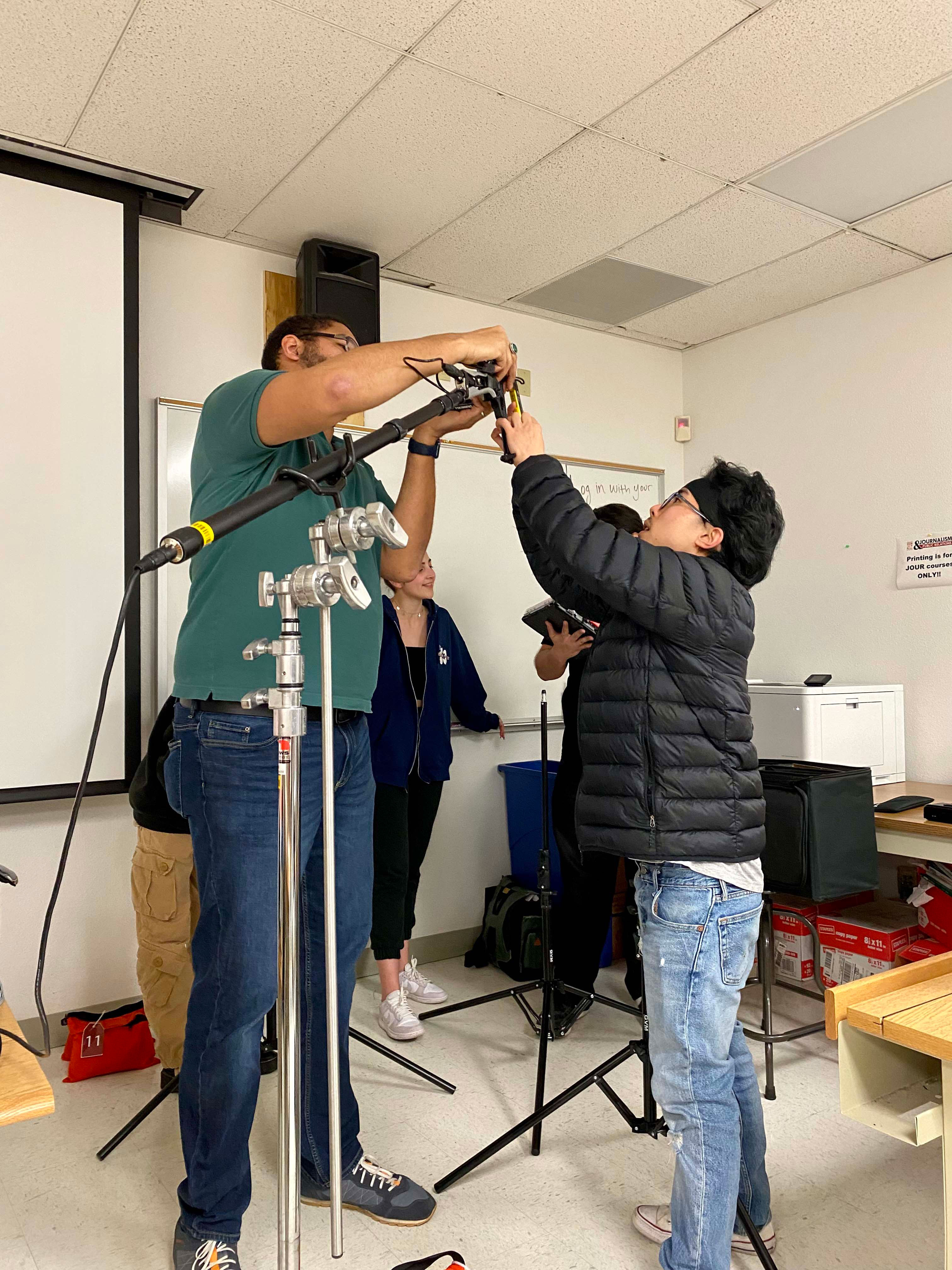 John Chiu working with Professor, Quinn Winchell, to set up the sound equipment.